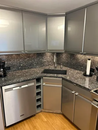 a kitchen with stainless steel appliances granite countertop a sink and a microwave