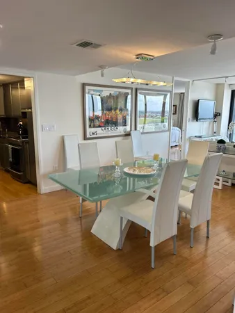 a view of a dining room with furniture and wooden floor