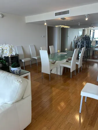 a dining room with furniture and wooden floor