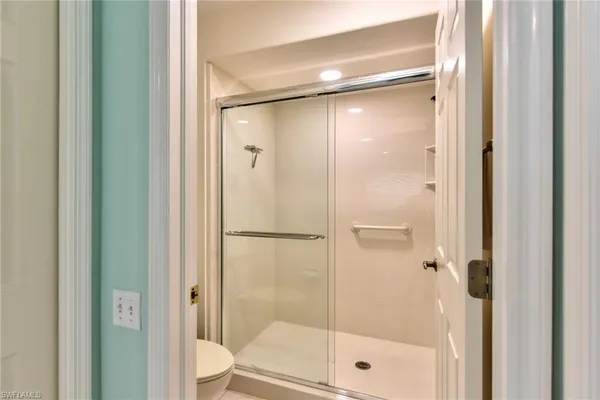 a bathroom with a glass shower door