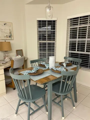 a view of a dining room and livingroom with furniture wooden floor and a rug