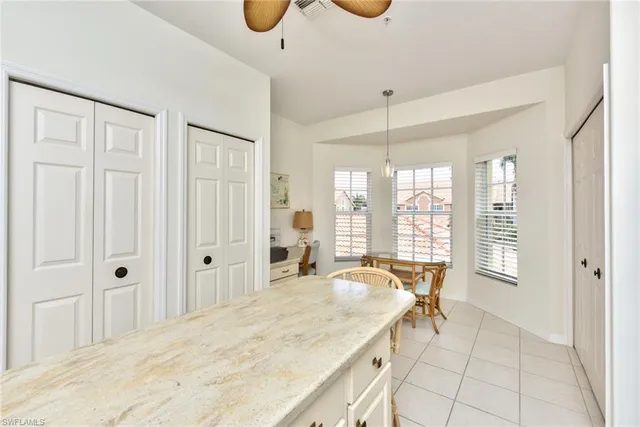 a spacious bathroom with a granite countertop sink a mirror and a bathtub