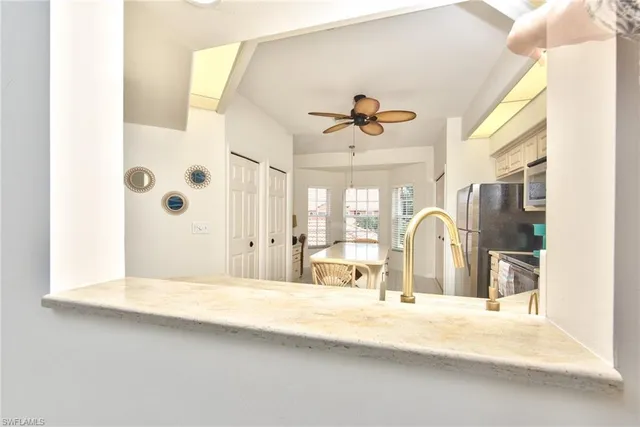 a large white kitchen with a large window