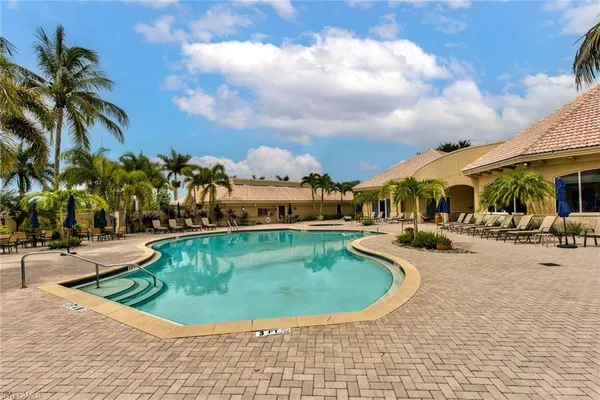 a view of a swimming pool with a lounge chair