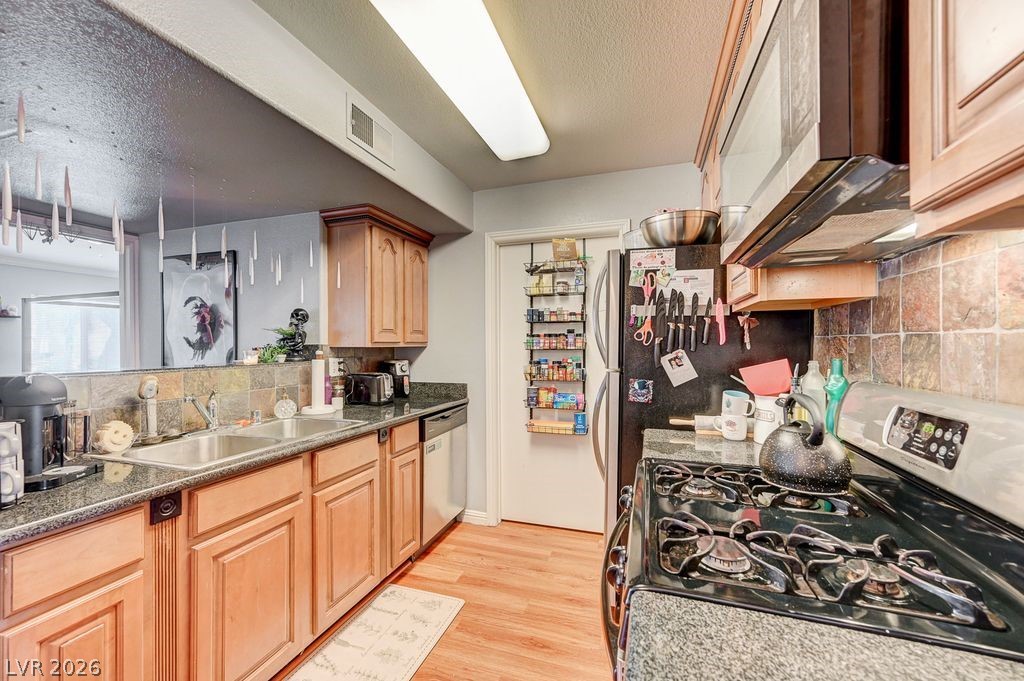 7885 West Flamingo Road, Unit 1079 Las Vegas, NV 89147 - Photo 16 of 35 This functional kitchen provides a practical layout for culinary endeavors.