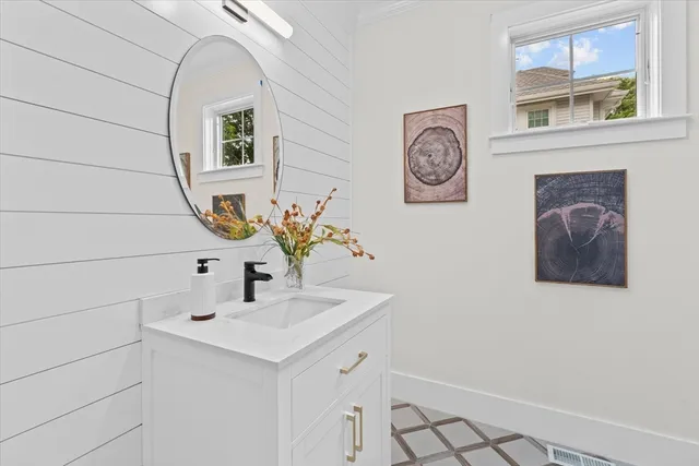 a bathroom with a granite countertop double vanity sink and a mirror