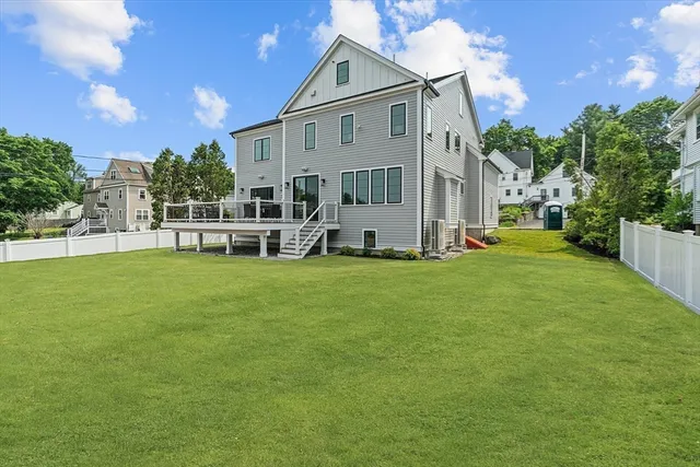 a balcony with wooden floor table and chairs