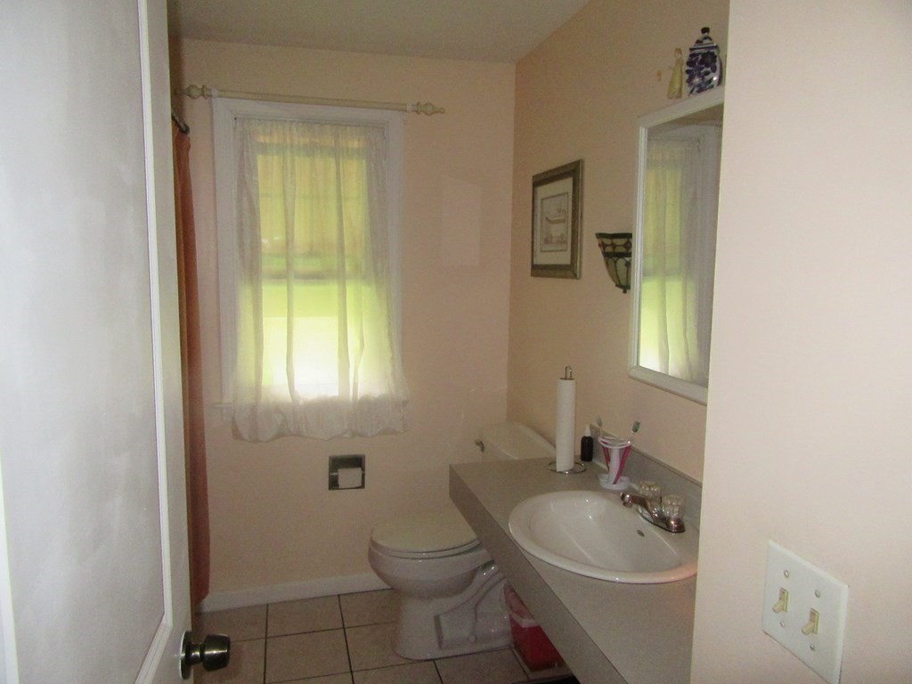 92 Maebeth Street Springfield, MA 01119 - Photo 14 of 21 a bathroom with a sink toilet and mirror