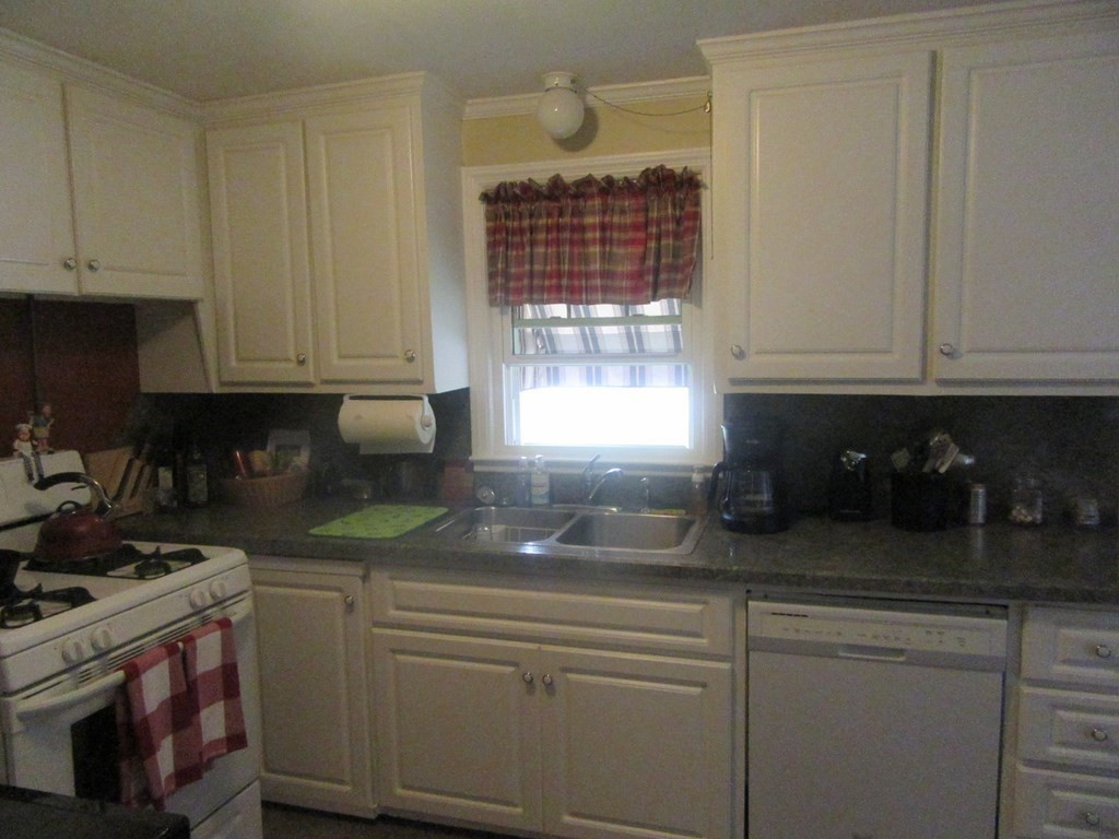 92 Maebeth Street Springfield, MA 01119 - Photo 18 of 21 a kitchen with granite countertop a sink a stove and cabinets