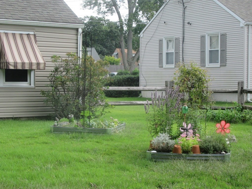 92 Maebeth Street Springfield, MA 01119 - Photo 6 of 21 a view of a house with a backyard and garden