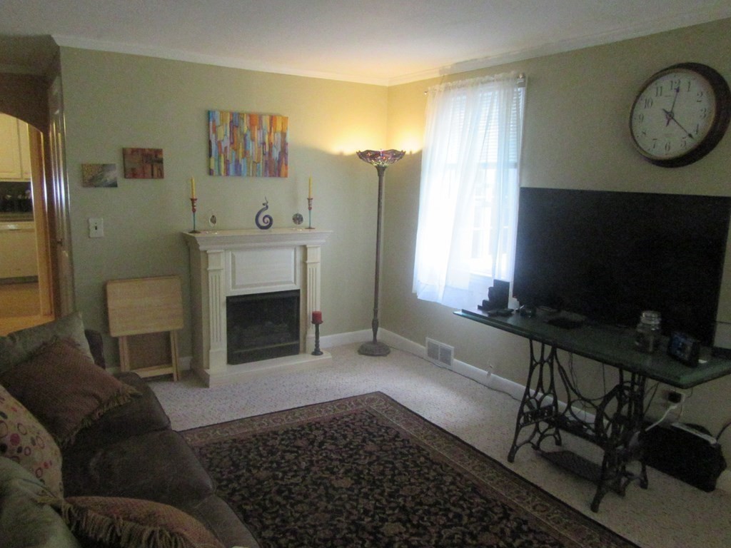 92 Maebeth Street Springfield, MA 01119 - Photo 9 of 21 a living room with furniture and a fireplace