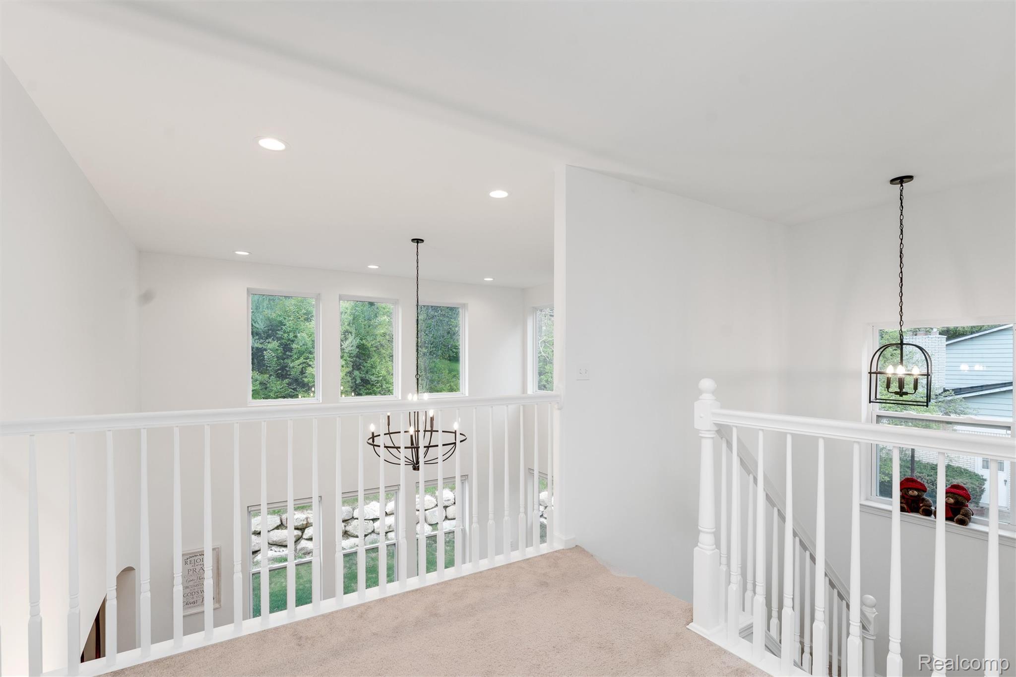 908 South Livernois Road Rochester, MI 48309 - Photo 22 of 49 Hallway featuring suspended lighting, carpet, and an upstairs landing