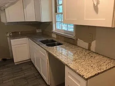 a kitchen with a sink and cabinets