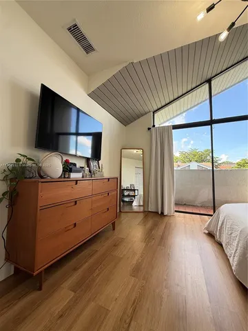 a room with furniture and a floor to ceiling window