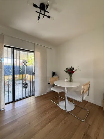 a work room with wooden floor and windows