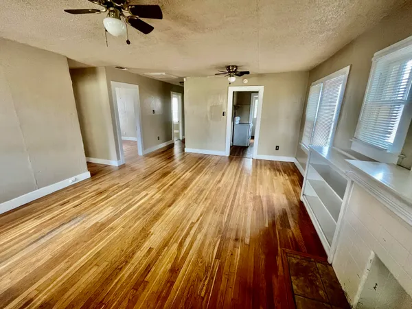 a view of a room with a sink and wooden floor