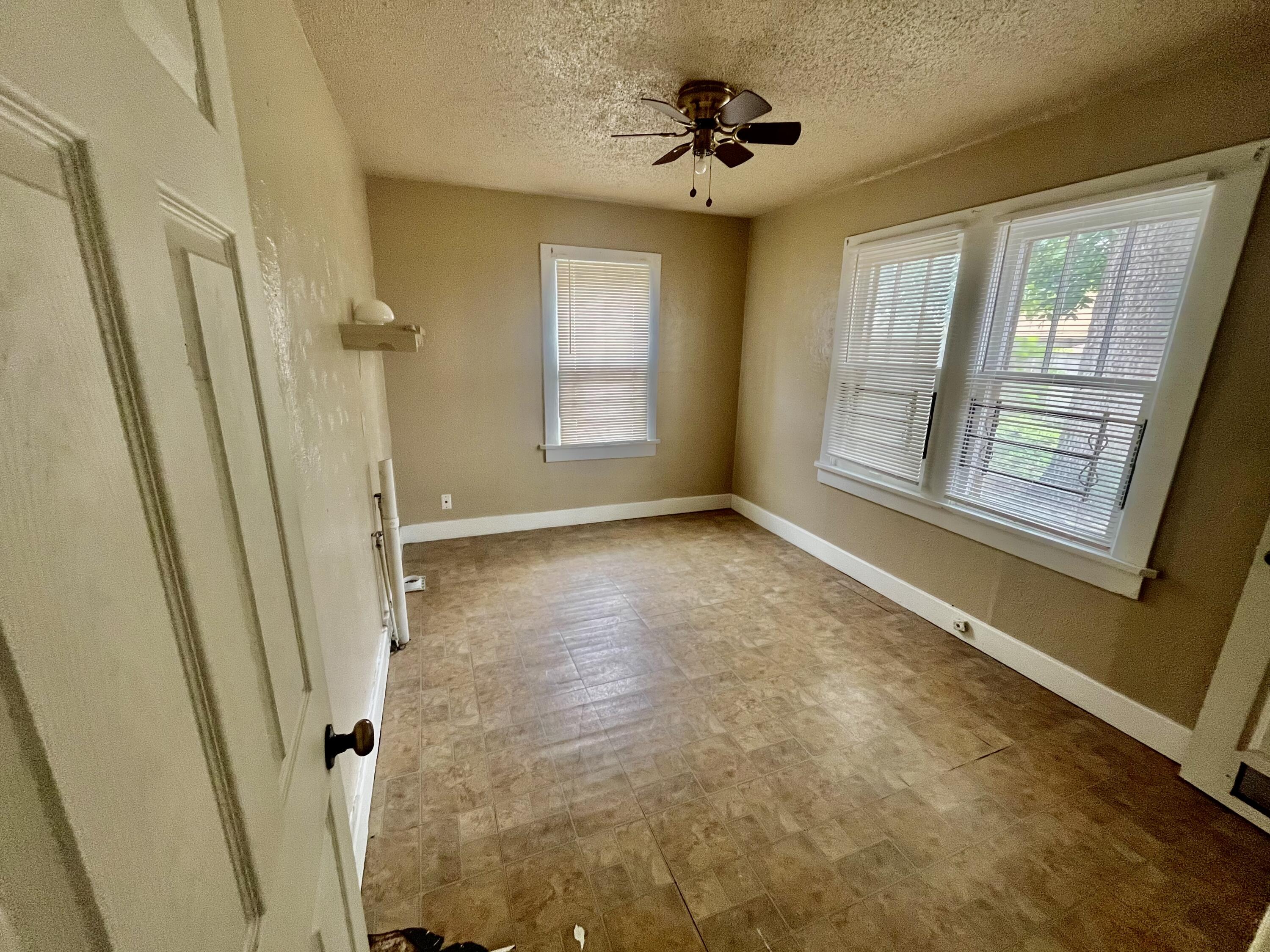 2121 17th Street Lubbock, TX 79401 - Photo 5 of 10 a view of an empty room with a window