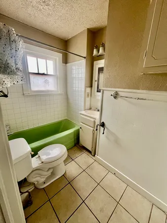 a bathroom with a toilet sink and window