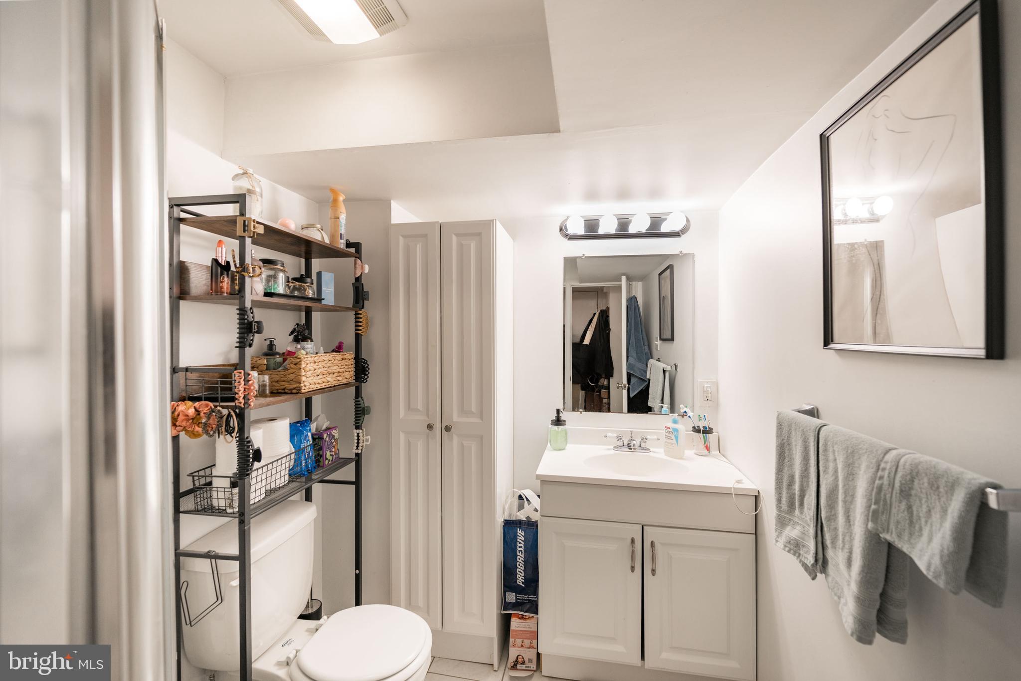 1728 Spruce Street, Unit B Philadelphia, PA 19103 - Photo 10 of 13 a bathroom with a toilet sink and mirror