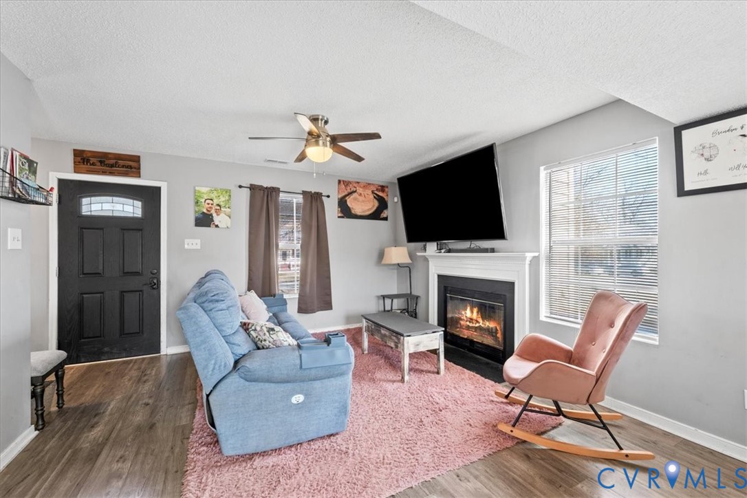 14126 Bermuda Point Court Chester, VA 23836 - Photo 28 of 50 a living room with furniture a fireplace and a flat screen tv