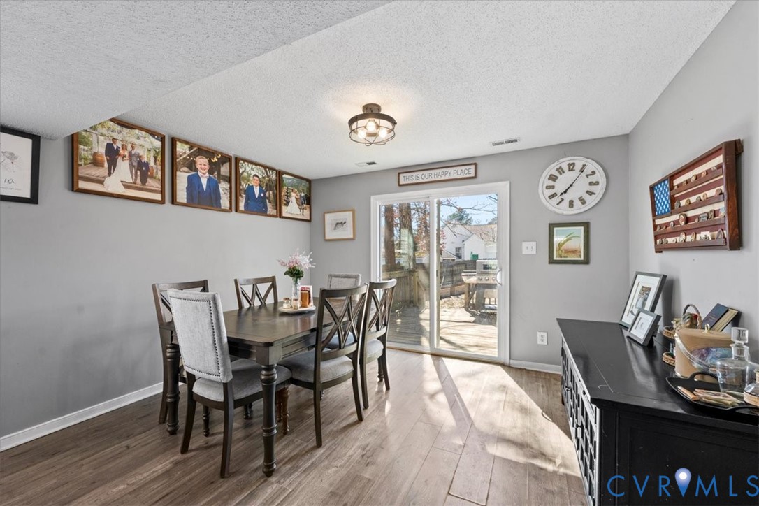14126 Bermuda Point Court Chester, VA 23836 - Photo 30 of 50 a view of a dining room with furniture window and wooden floor