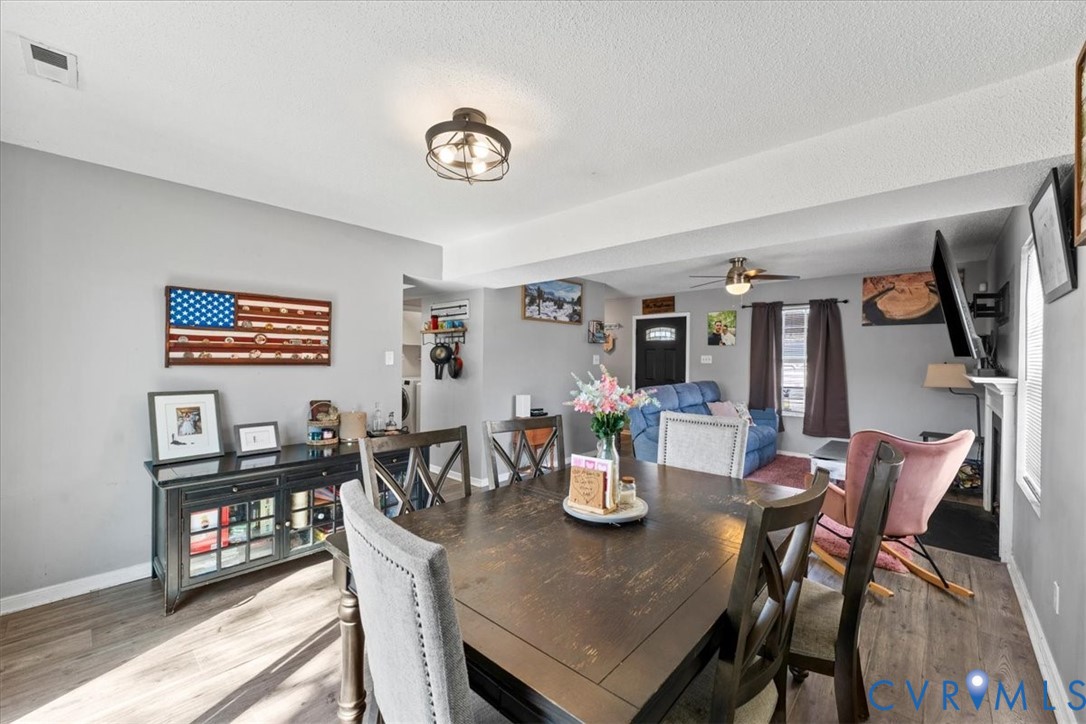 14126 Bermuda Point Court Chester, VA 23836 - Photo 31 of 50 a view of a dining room and livingroom with furniture wooden floor a rug and a painting