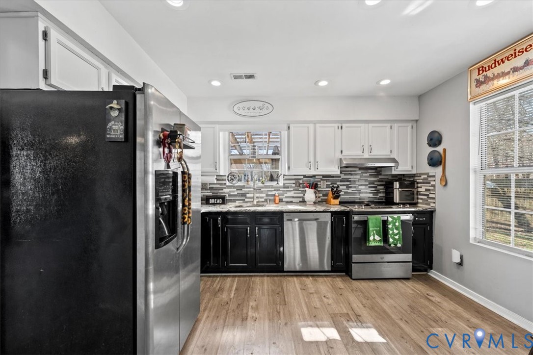 14126 Bermuda Point Court Chester, VA 23836 - Photo 32 of 50 a kitchen with stainless steel appliances granite countertop a refrigerator and a sink