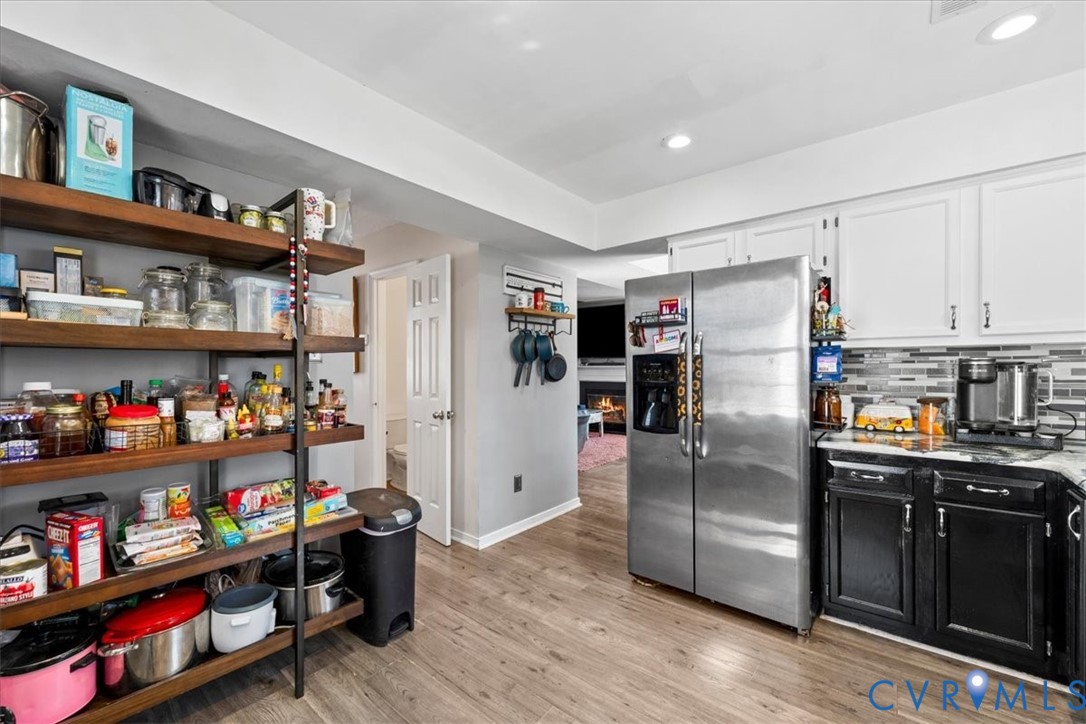 14126 Bermuda Point Court Chester, VA 23836 - Photo 34 of 50 a kitchen with stainless steel appliances a refrigerator and wooden floor