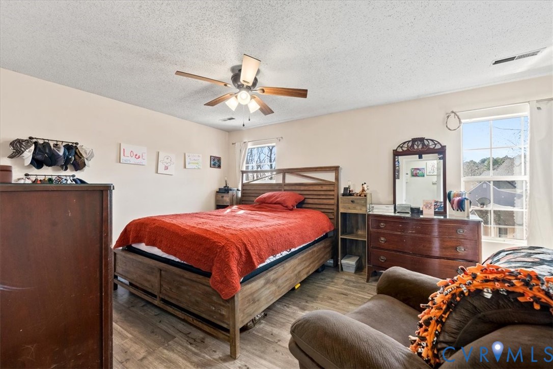 14126 Bermuda Point Court Chester, VA 23836 - Photo 42 of 50 a bedroom with a bed and wooden floor
