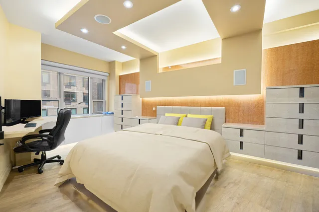 a spacious bedroom with a bed and a desk