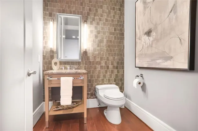 a bathroom with a toilet sink and mirror