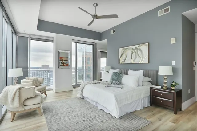 a bedroom with a bed and glass walk in closet