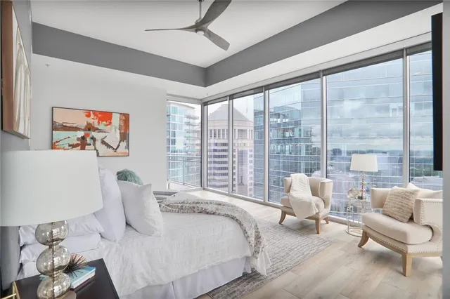 a spacious bedroom with a bed and a large window