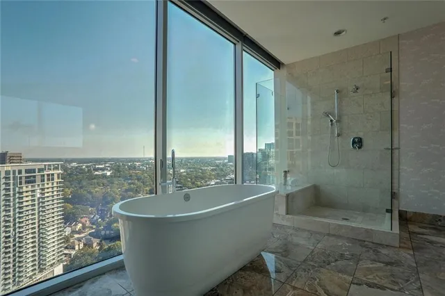 a bathroom with a bathtub and shower