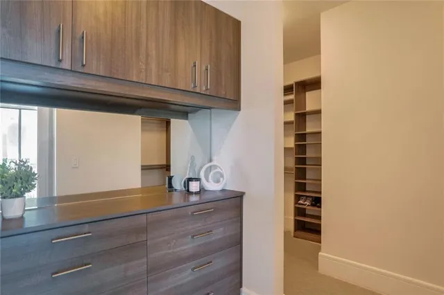 a kitchen with granite countertop white cabinets and black appliances