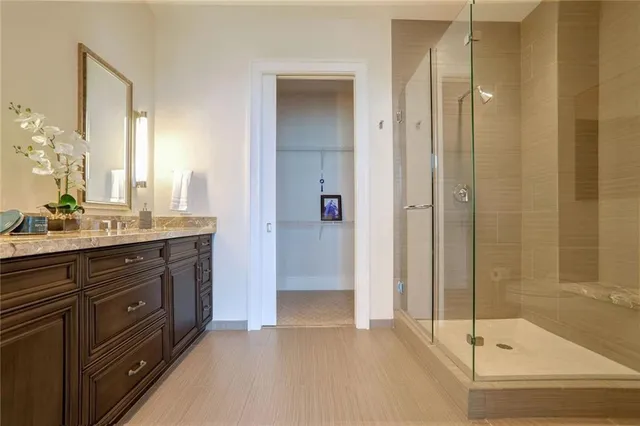 a bathroom with a shower sink and mirror