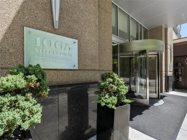 a sign that is sitting in front of flowers