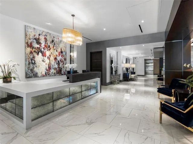 a view of a kitchen with stainless steel appliances granite countertop a sink and cabinets
