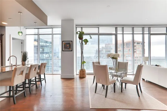 a dining room with furniture window and wooden floor