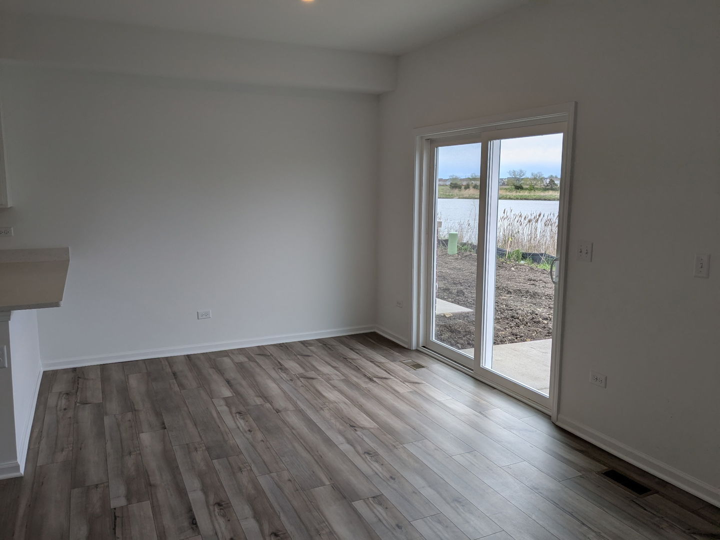 7828 Nightshade Lane Joliet, IL 60431 - Photo 17 of 23 an empty room with wooden floor and windows