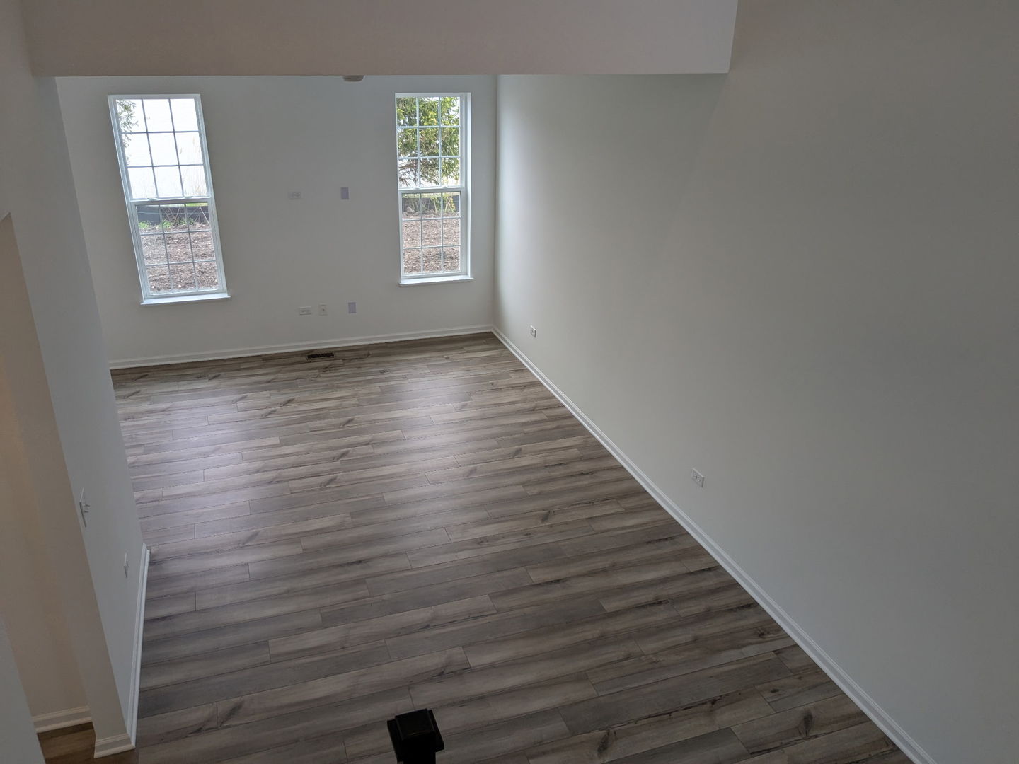 7828 Nightshade Lane Joliet, IL 60431 - Photo 18 of 23 an empty room with wooden floor and windows