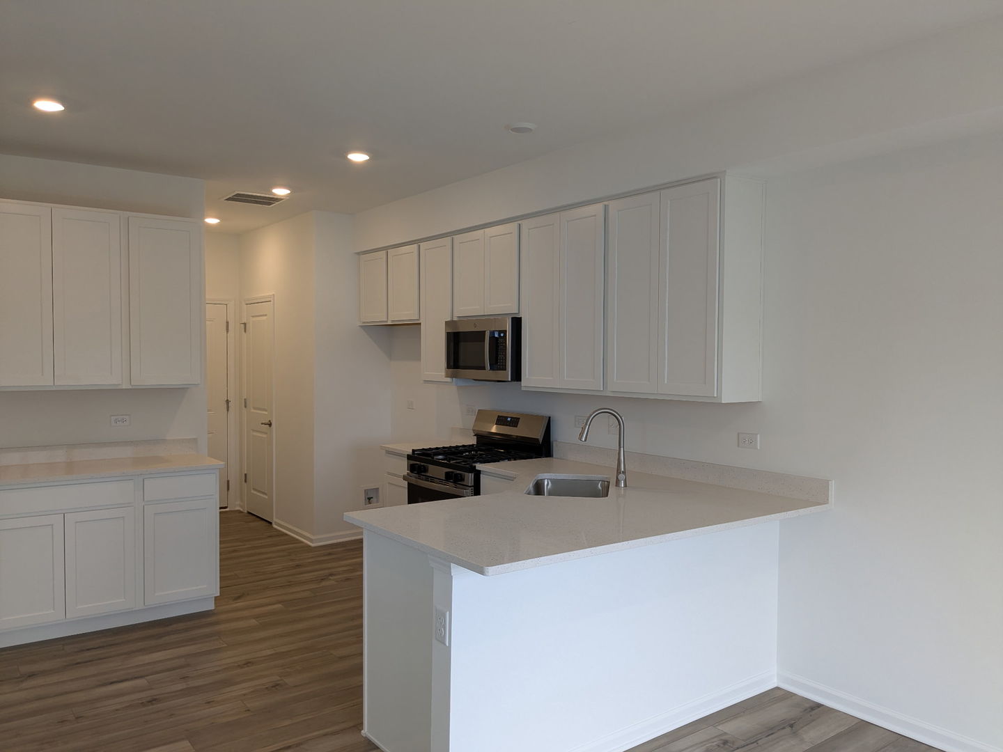 7828 Nightshade Lane Joliet, IL 60431 - Photo 4 of 23 a kitchen with stainless steel appliances a sink a stove a microwave a sink a refrigerator and cabinets