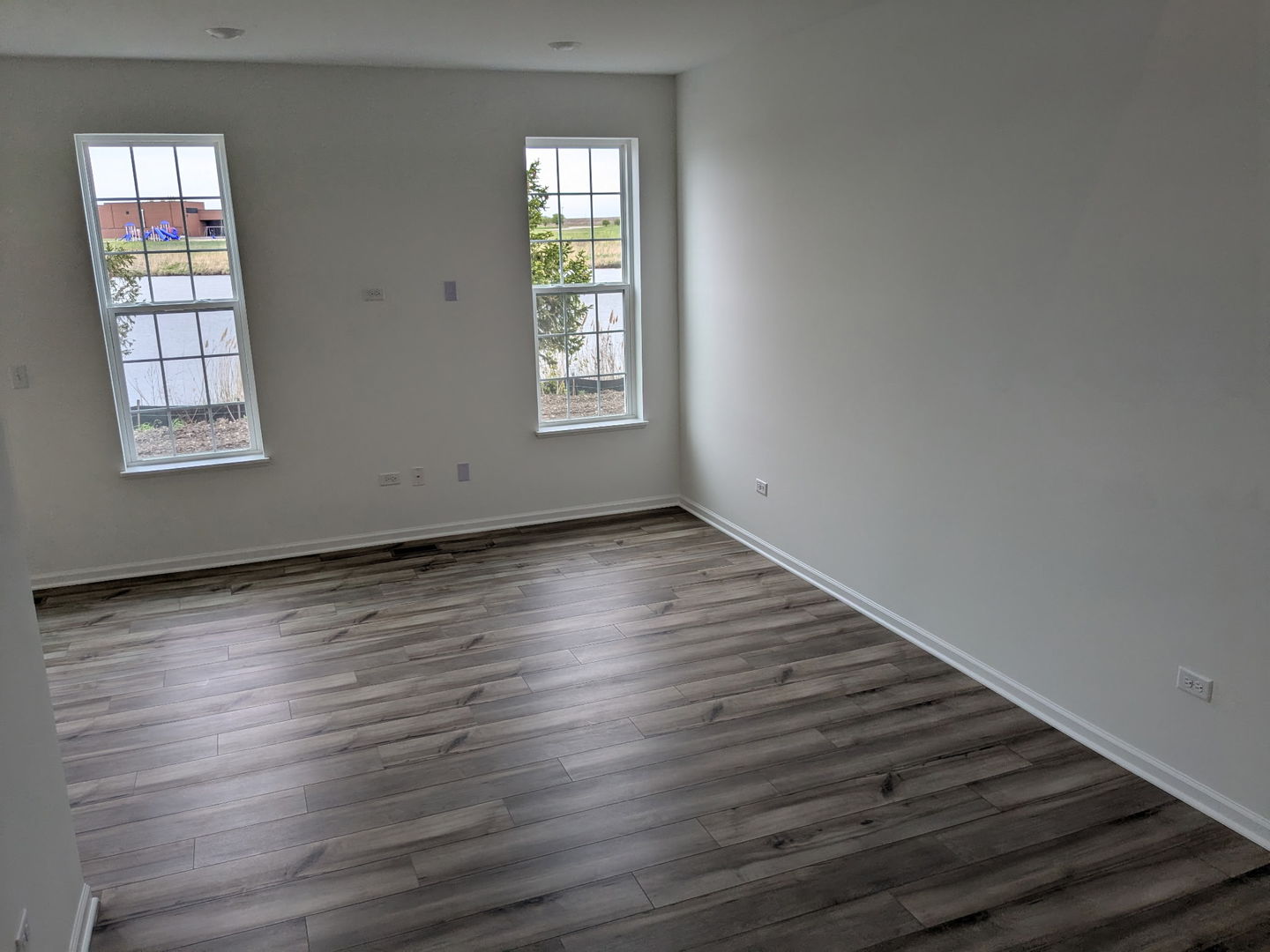 7828 Nightshade Lane Joliet, IL 60431 - Photo 10 of 23 an empty room with wooden floor and windows