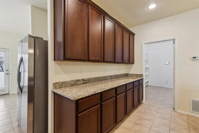 a kitchen with stainless steel appliances granite countertop a refrigerator and a sink