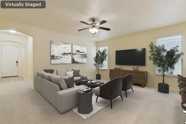 a living room with furniture and a flat screen tv