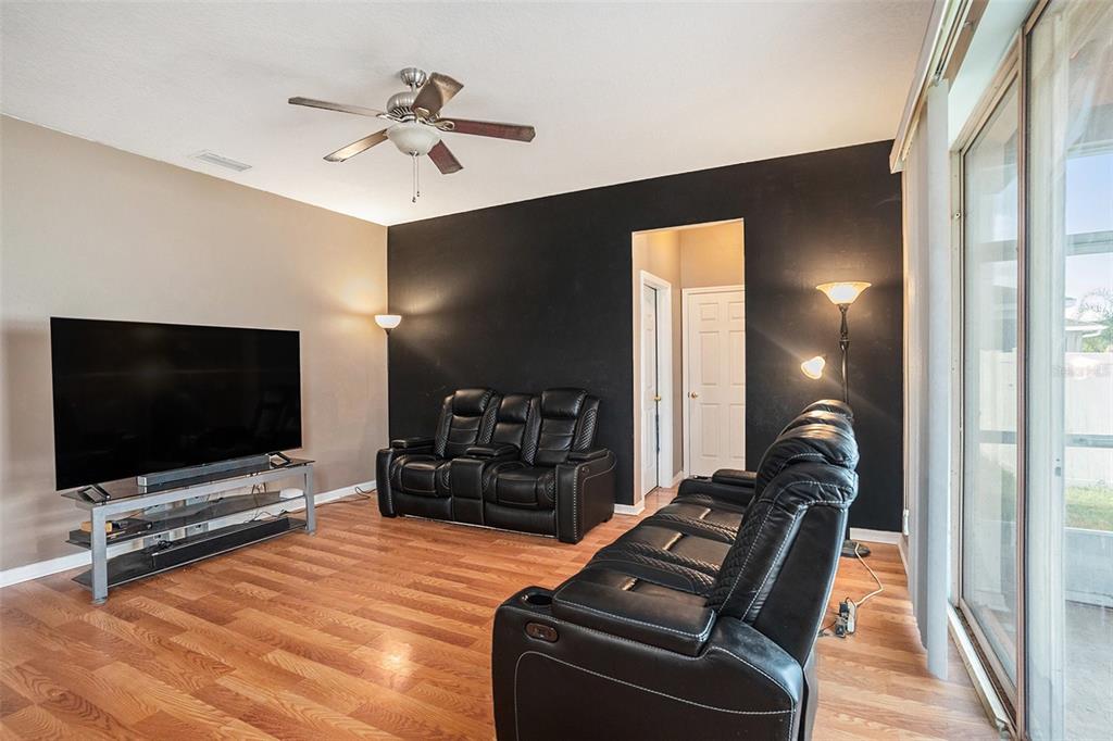 7641 Armonk Lane Wesley Chapel, FL 33545 - Photo 12 of 34 a living room with furniture and a flat screen tv