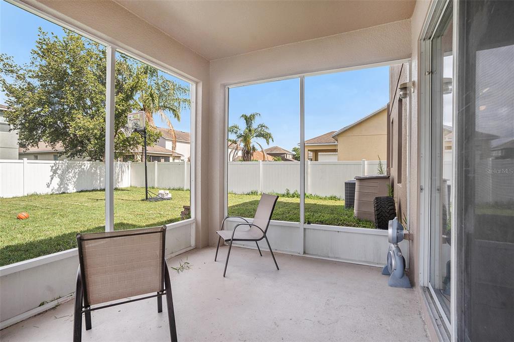 7641 Armonk Lane Wesley Chapel, FL 33545 - Photo 27 of 34 a view of a two chairs and table in a big yard
