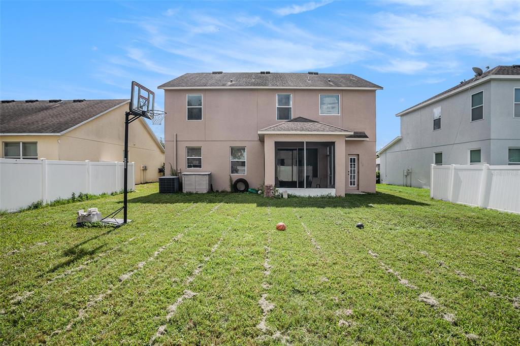 7641 Armonk Lane Wesley Chapel, FL 33545 - Photo 28 of 34 a view of a house with backyard and garden