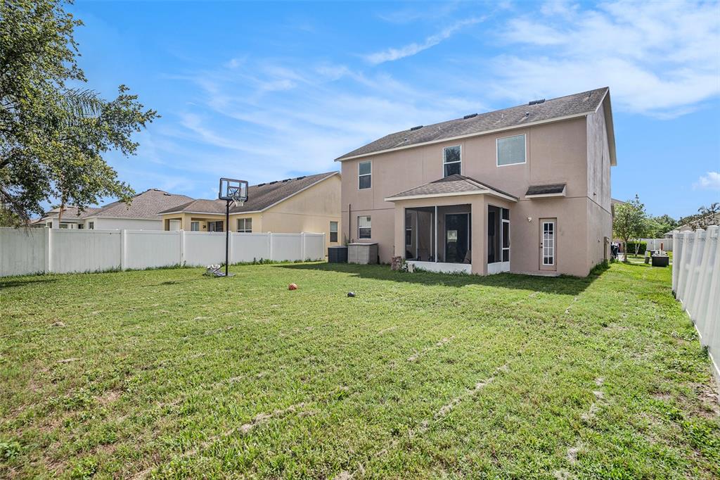 7641 Armonk Lane Wesley Chapel, FL 33545 - Photo 29 of 34 a front view of a house with garden