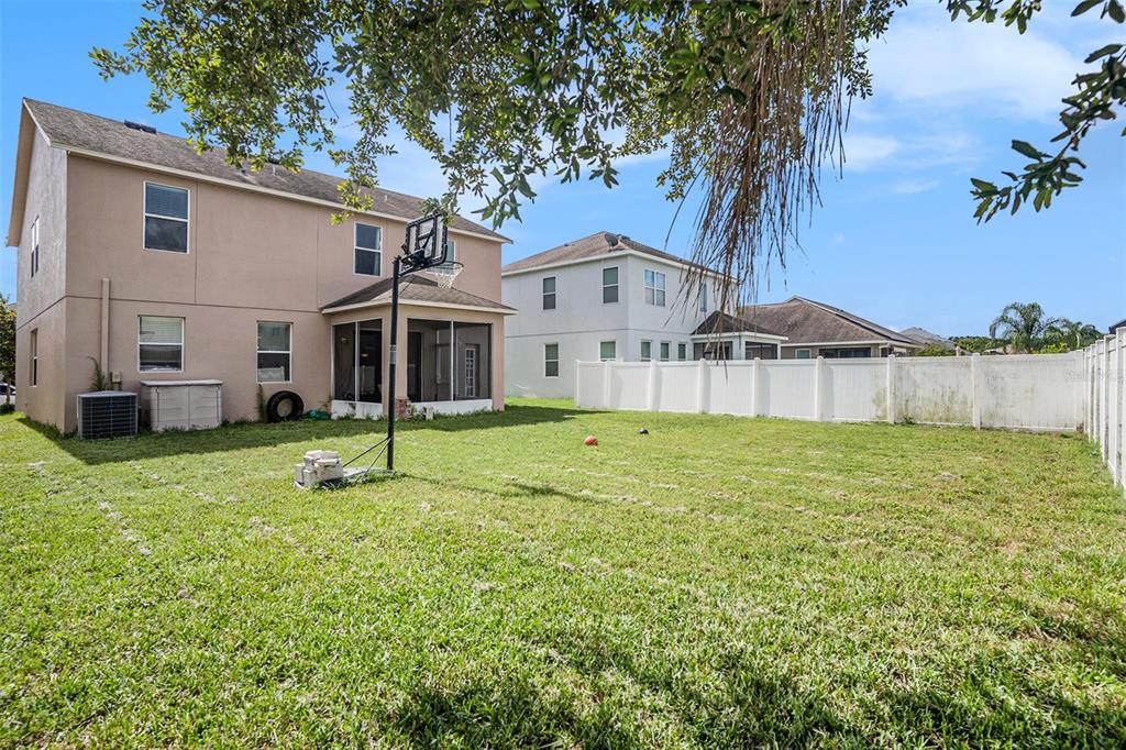 7641 Armonk Lane Wesley Chapel, FL 33545 - Photo 30 of 34 a view of a house with a backyard
